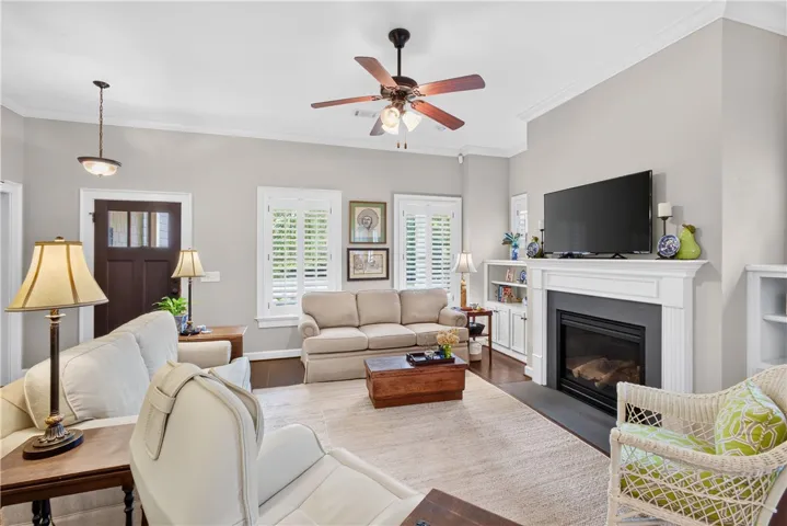 A comforting living space features a cozy fireplace and warm wood flooring.