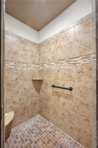 Indulge in a rejuvenating experience within this meticulously tiled walk-in shower.