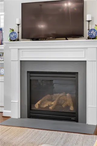A refined fireplace with a classic white mantel anchors this elegant living space.