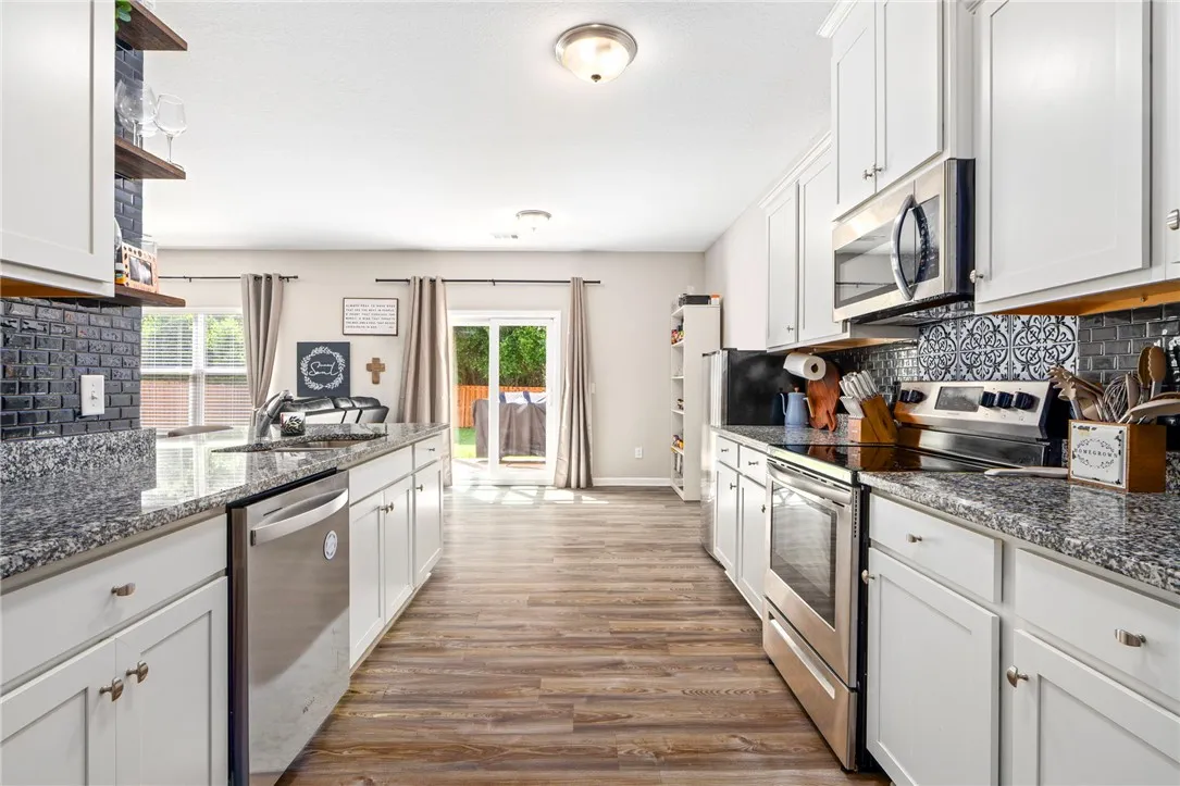 Culinary haven with stainless steel appliances and ample counter space, extending seamlessly to the outdoor patio.
