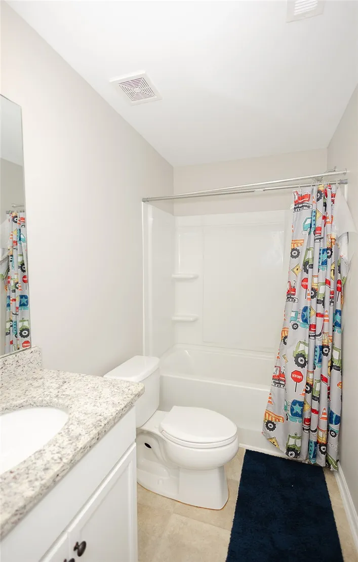 A well-maintained bathroom with a sleek vanity and convenient shower-tub combination.
