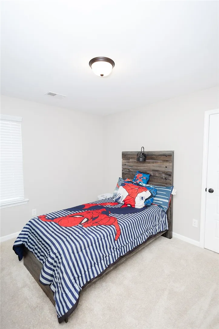 A well-lit bedroom provides comfortable personal space for relaxation and rest.