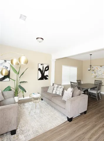 An inviting open floorplan seamlessly connects the living area to the dining space, creating an ideal setting for gatherings.