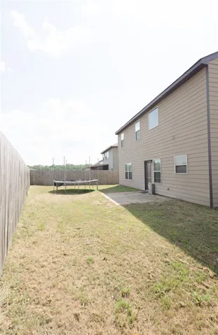 A spacious backyard awaits, complete with a private fence for outdoor enjoyment.