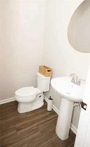 Compact and clean, this half bath offers a functional and stylish space.