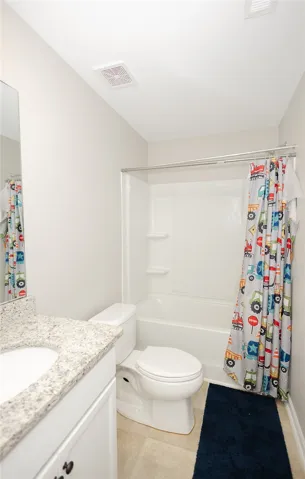 A well-maintained bathroom with a sleek vanity and convenient shower-tub combination.