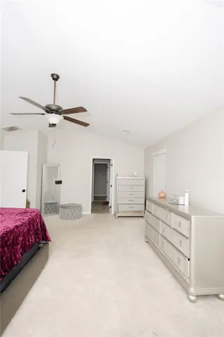 A vaulted ceiling enhances the spacious feel of this comfortable bedroom.