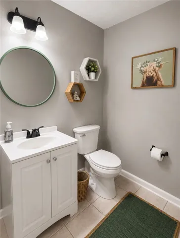 A well-appointed lavatory showcases a clean white vanity and neutral tile flooring.