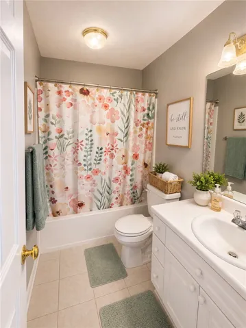Functional bathroom offering a single vanity with ample storage and a classic tub/shower combination.