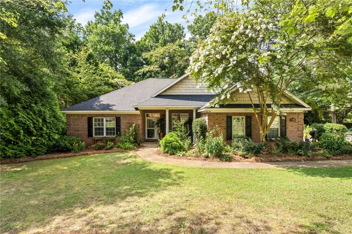A classic brick exterior offers traditional charm with inviting front landscaping.