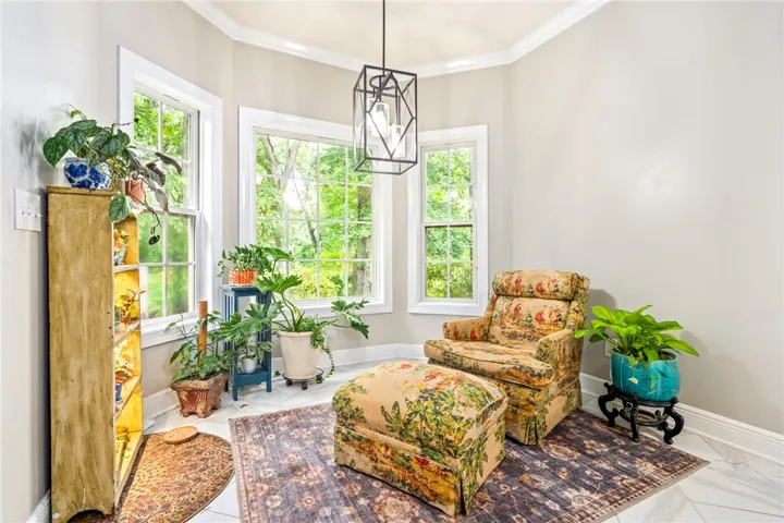 The breakfast room offers abundant natural light and serene views of the surrounding greenery.