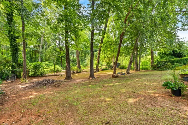 Lush, mature trees create a private, green oasis.