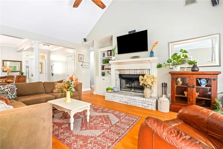 A welcoming living area showcases a white brick fireplace with built-in shelving, perfect for gatherings.
