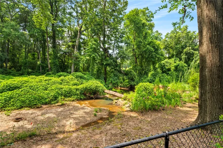 Lush, mature trees create a private, green oasis.