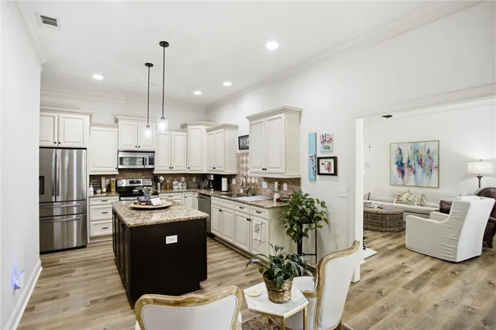 Culinary creativity thrives in this well-appointed kitchen, featuring a spacious island and seamless flow into the adjoining living area.