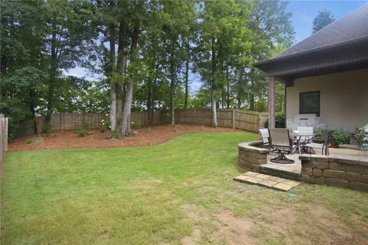 A well-maintained fenced yard offers a private patio area perfect for outdoor relaxation.