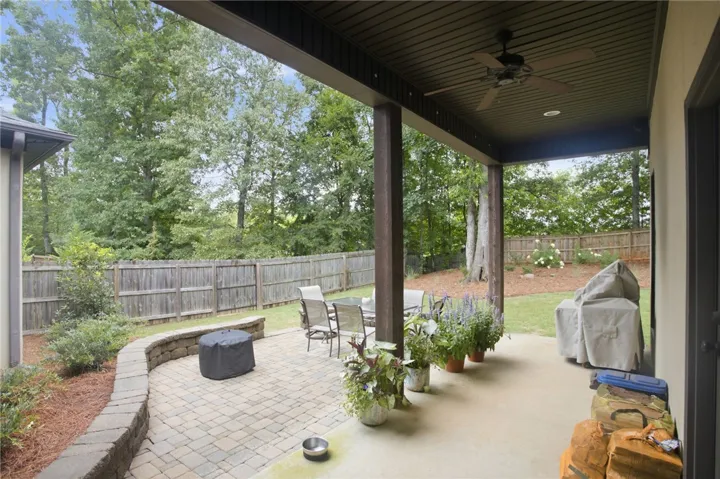 A spacious covered patio provides a delightful outdoor living area, perfect for entertaining guests.
