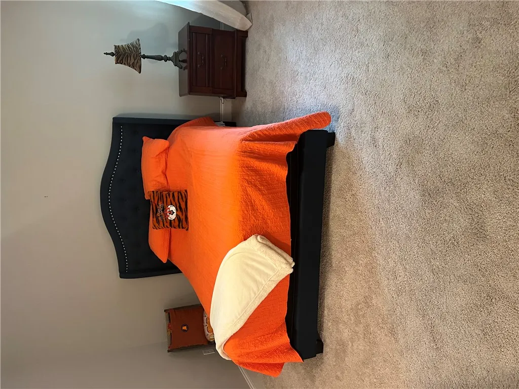 Primary bedroom has plush carpeting creating a serene atmosphere for peaceful slumber in this well-appointed room.