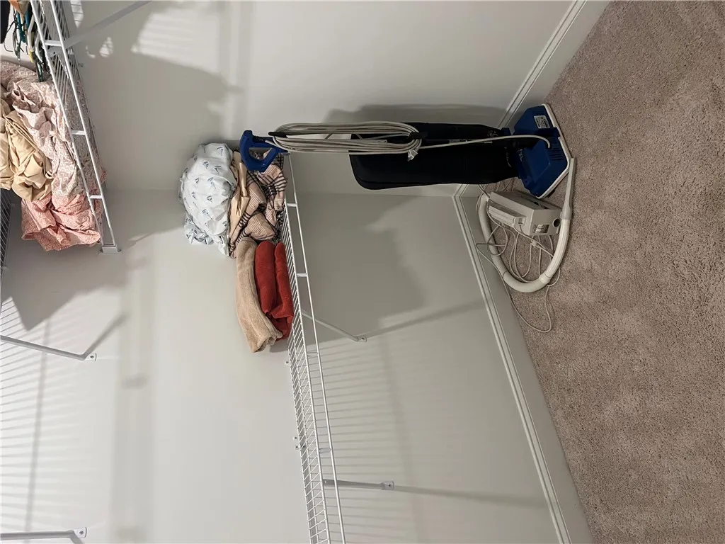 Functional wire shelving provides ample storage in this organized walk-in closet.