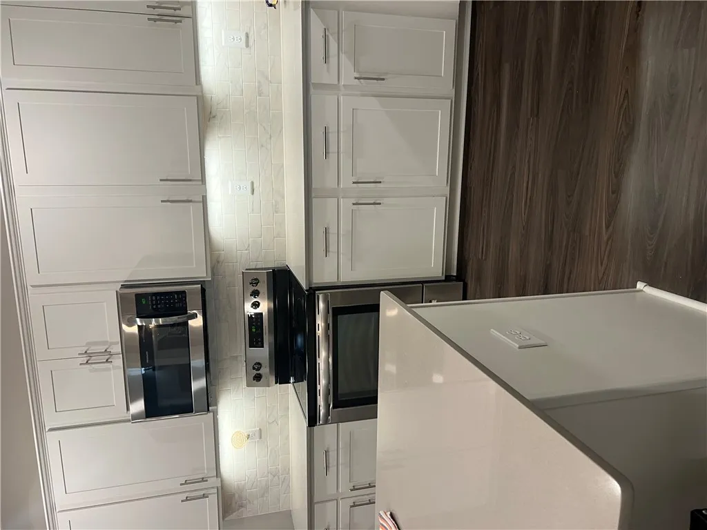 Culinary delights await in this sleek kitchen featuring contemporary cabinetry and a versatile center island.