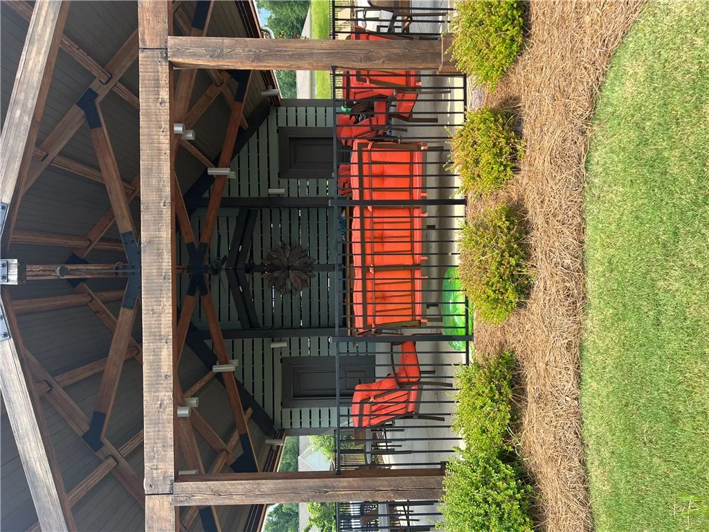 A grand outdoor pavilion with exposed timber framing provides a welcoming community gathering space.