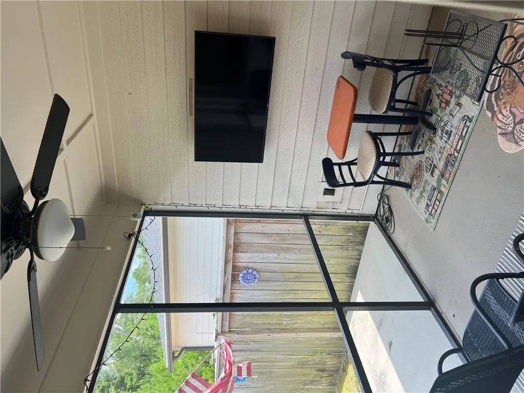 A breezy screened patio with ample space provides an ideal setting for casual outdoor dining.