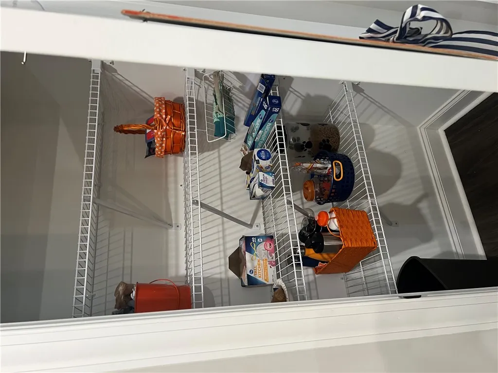 Functional wire shelving optimizes storage within this versatile pantry space.