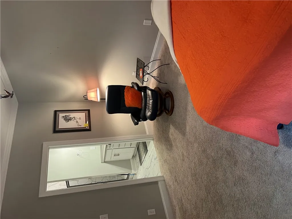 Comfortable carpet flooring creates a soft foundation in this inviting bedroom.