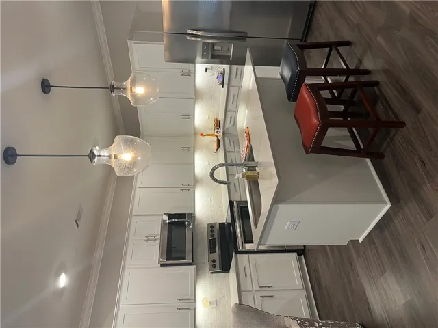 Modern kitchen with sleek stainless steel appliances and an inviting island for casual dining.