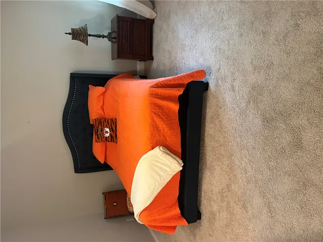Primary bedroom has plush carpeting creating a serene atmosphere for peaceful slumber in this well-appointed room.