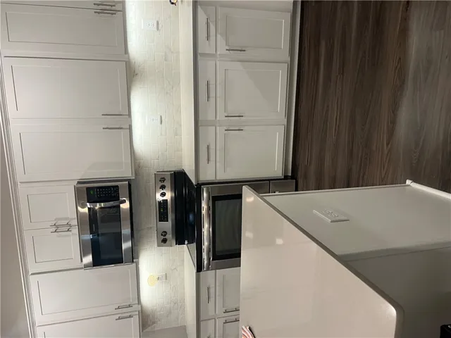 Culinary delights await in this sleek kitchen featuring contemporary cabinetry and a versatile center island.