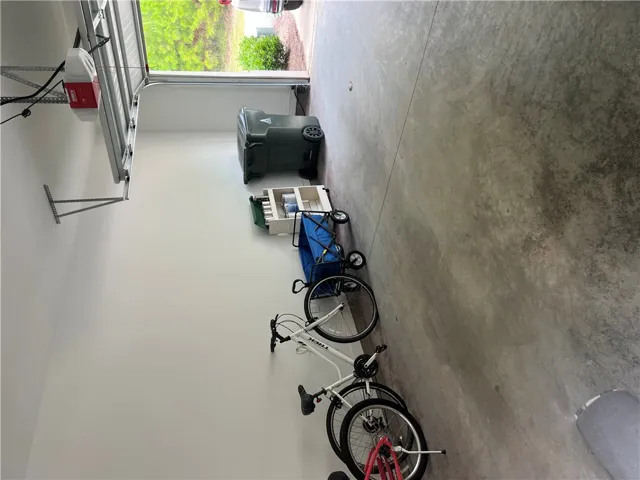 A well-maintained concrete garage floor offers ample space with convenient overhead door access.