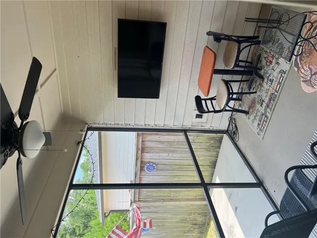A breezy screened patio with ample space provides an ideal setting for casual outdoor dining.