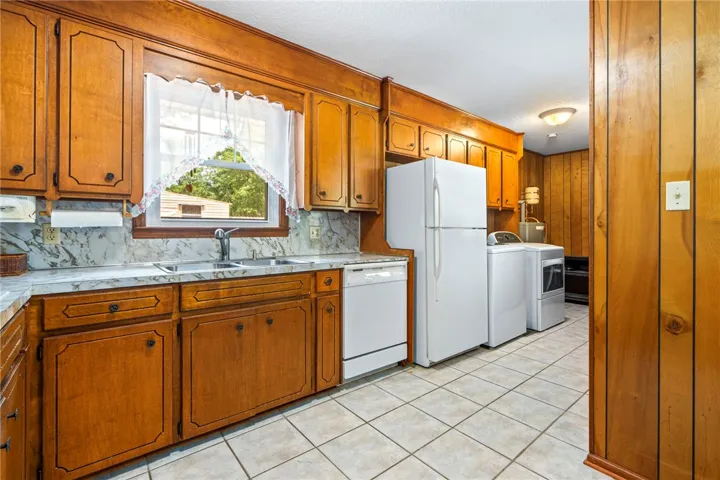 A functional kitchen space combines meal preparation and laundry duties for practical living.