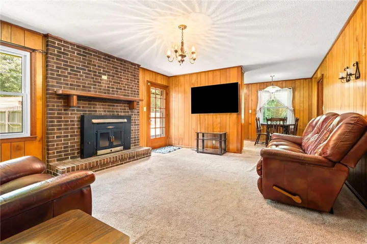 A classic brick fireplace anchors this inviting living space, providing warmth and character.