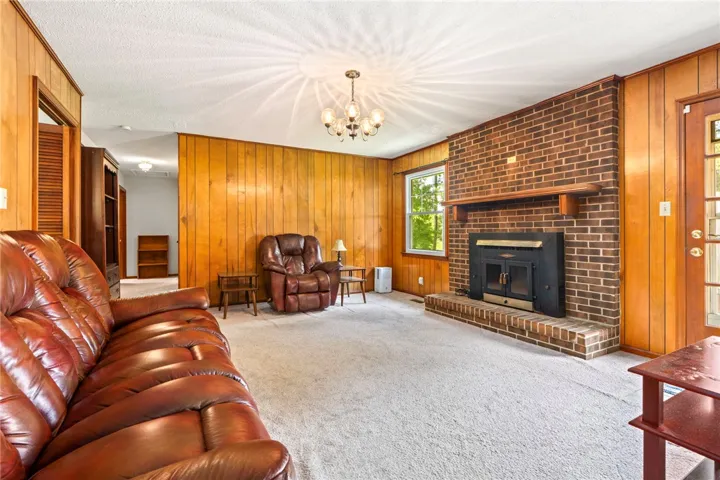 A classic brick fireplace anchors this inviting living space, offering warmth and traditional charm.