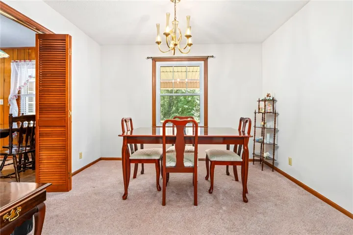 A window-framed dining room provides a bright space for meals and gatherings.