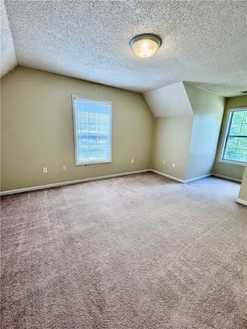 A quiet and adaptable space with a warm carpeted floor awaits your personal touch.