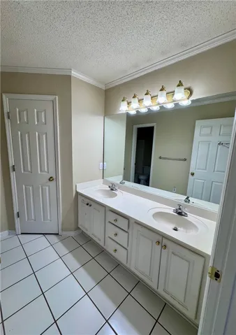 Double vanity with ample counter space and a large mirror defines this functional bathroom.