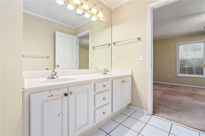 Double vanity with ample counter space provides functional elegance for daily routines.