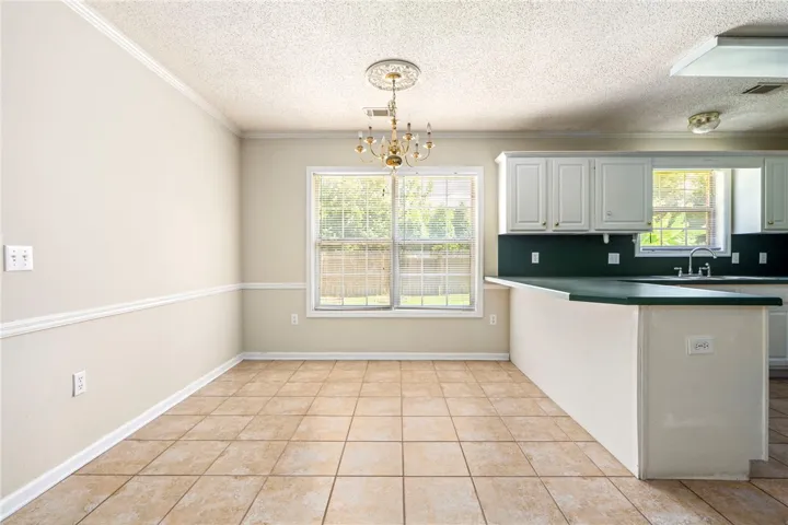 Functional kitchen with ample cabinet space and a bright window overlooking the backyard.