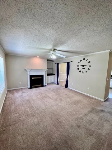A comfortable living area with carpeted floors and a warm fireplace.