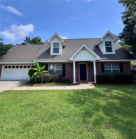A classic brick facade welcomes you home with a double garage and dormer windows.