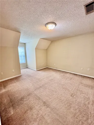 A quiet retreat with a cozy carpeted floor awaits your personal touch.