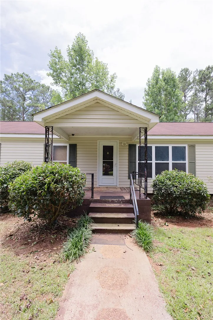 A welcoming front entrance features a classic porch with wrought iron accents, enhancing its curb appeal.