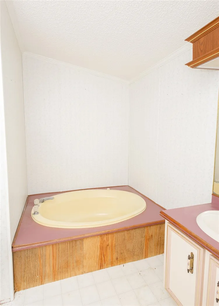 Indulge in a relaxing soak within this built-in oval tub, complemented by a convenient adjacent vanity.