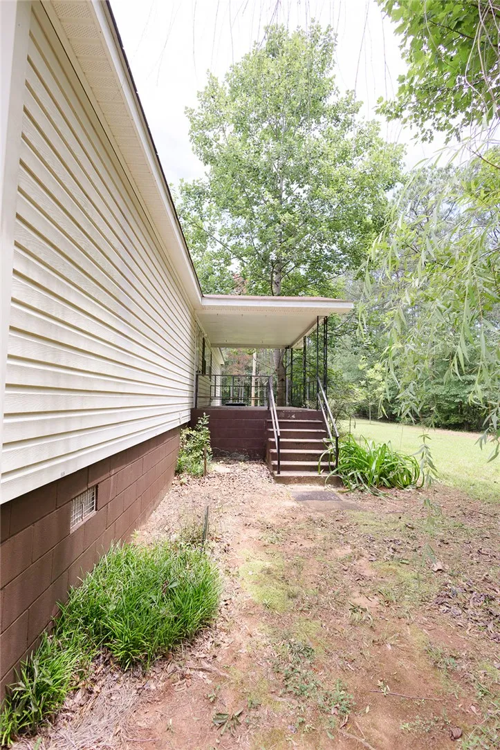 A welcoming side entrance with a covered porch provides access to this charming residence.