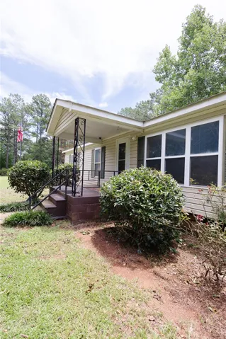 A welcoming front porch with decorative iron railings enhances this home's inviting facade.