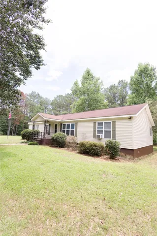 A welcoming front porch and mature trees create a serene and private residential setting.
