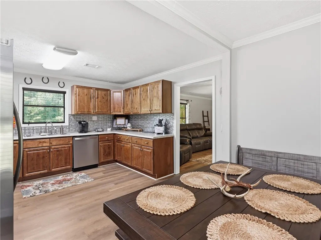 A well-equipped kitchen offers ample wooden cabinetry and a clear view of the living space.